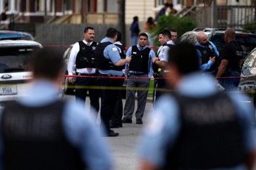 CHICAGO, IL - APRIL 25: Chicago Police stand near the scene where a 16-year-old boy was shot in the head and killed and another 18-year-old man was shot and wounded on the 7300 block of South Sangamon Street on April 25, 2016 in Chicago, Illinois. Last week Chicago reached over 1,000 people shot since the beginning of the year. (Photo by Joshua Lott/Getty Images)